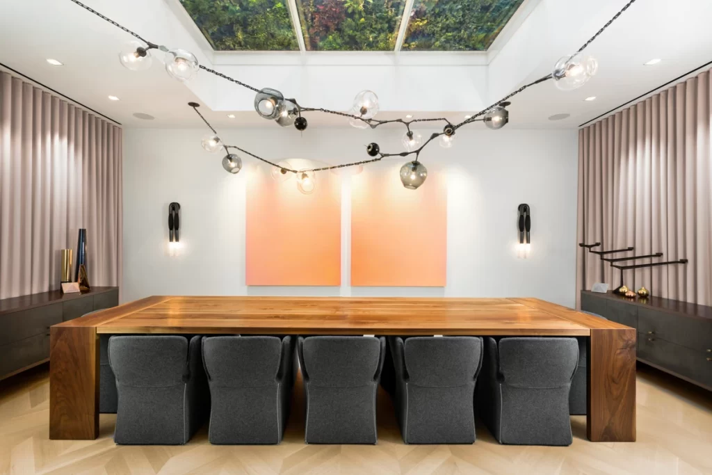 Exuberant chandelier with glass globes suspended above a dinning table.