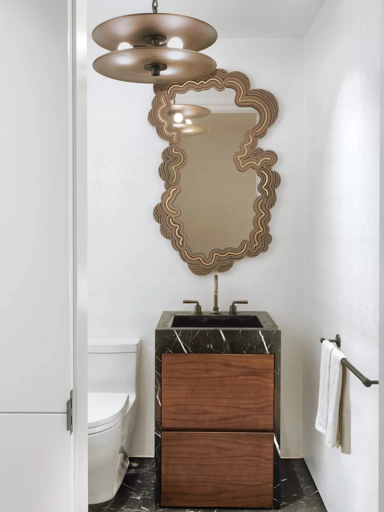 Powder room with Campana brothers sushi mirror.
