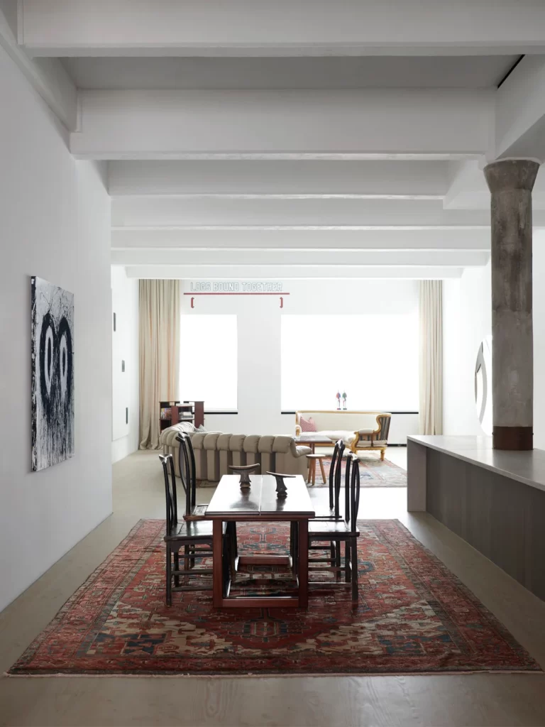 View of the dining room, next to it is a painting by Joyce Pensato. 