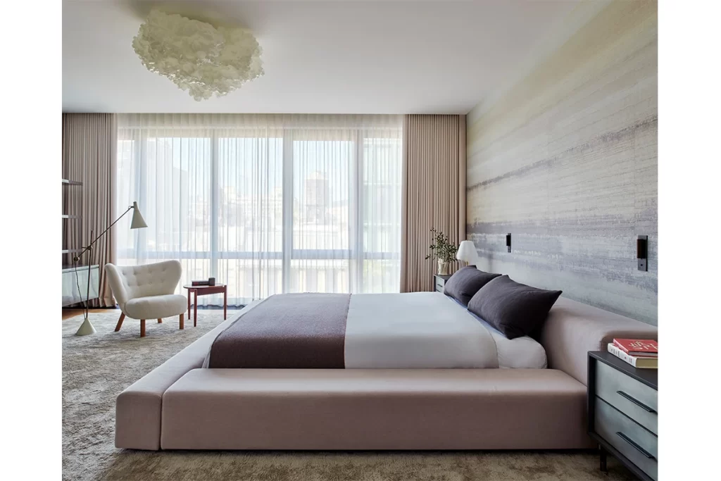 By the window is a reading corner with a Little Petra VB1 chair by &Tradition, a 1950s floor lamp by Tapio Wirkkala and a solid-walnut vintage side table.