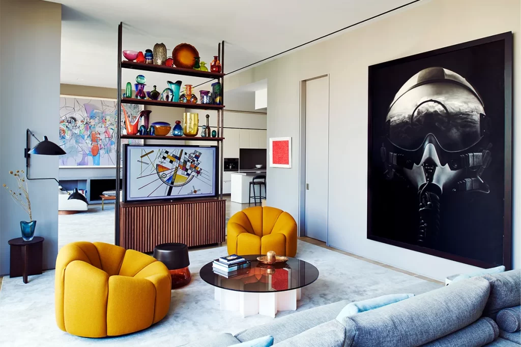 A custom room divider holds back-to-back TVs and a collection of glassware by such makers as Gio Ponti, Tapio Wirkkala, Oiva Toikka, Luigi Mellara and Ingeborg Lundin.