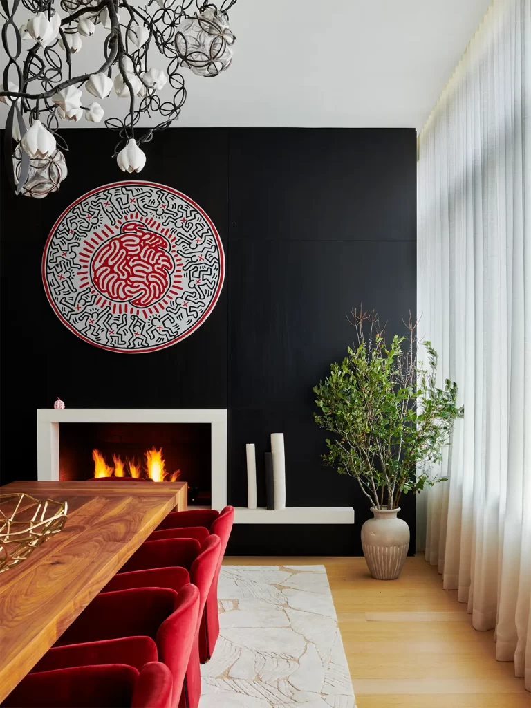 The artwork over the fireplace is by Keith Haring.