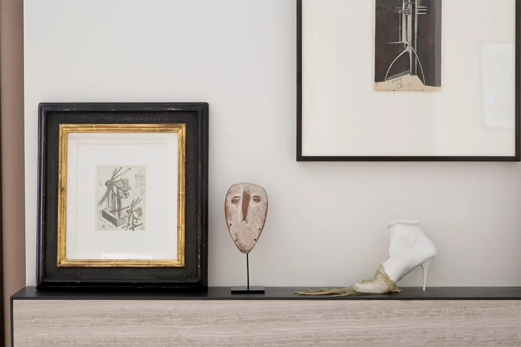 Drawing hanging above mantlepiece is by Julio Gonzalez, and on the mantlepiece is a Gonzalez'study, a Lega mask, and a sculpture by Birgit Jurgenssen. 