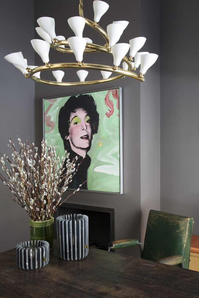 In the office space, a Gino Sarfatti spiral chandelier hangs above a Jean Prouve table and a Jules Leleu armchair. Painting by Andy Warhol.