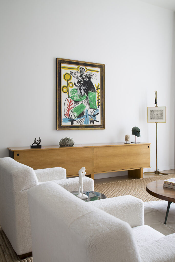 Pablo Picasso is the focal point above the Charlotte Perriand cabinet, which also carries a Jenry Moore sculpture, and Eva Zethraeus' porcelain.