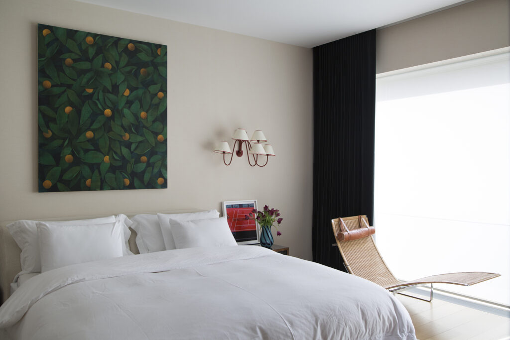 Bedroom with a sconce by Jean Royere.